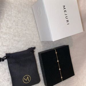 Mejuri mini lotus gold and white sapphire bracelet